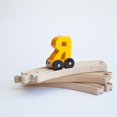 Russian wooden letter train car alphabet. Bright yellow color on wood railway a white background. Early childhood education, learning to read, preschool and kids game concept.
