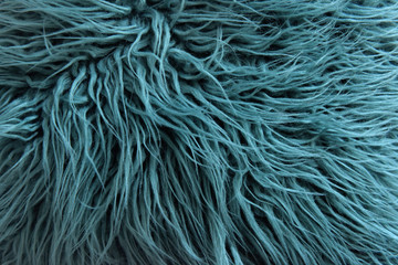green fabric made of faux fur with long nap used for clothing and furniture and bedspreads