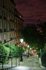 Paris, France - August 22, 2018: Stairs, lights and historical buildings on Montmartre by night