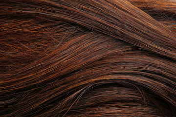Texture of healthy brown hair as background, closeup