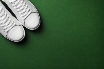 Pair of sneakers on color background, flat lay. Space for text