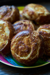 Fresh homemade open patties with cottage cheese and raisins. Traditional Russian pastry vatrushka, round buns, curd tart, top view