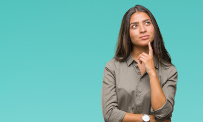 Young beautiful arab woman over isolated background with hand on chin thinking about question,...