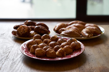 Homemade buns stuffed with cottage cheese, vegetables and chicken on a wooden table background.