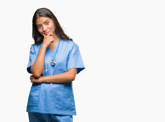 Young arab doctor surgeon woman over isolated background looking confident at the camera with smile...