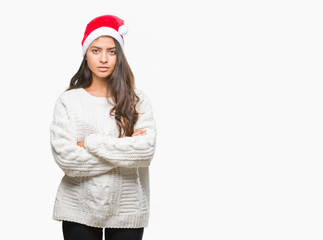 Young arab woman wearing christmas hat over isolated background skeptic and nervous, disapproving...