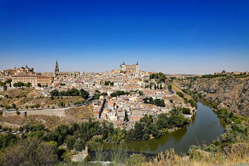 Fototapeta na wymiar Aerial view of the ancient city of Toledo, Spain, with the Targus River. The Alcazar and the Cathedral and churches are major tourist attractions.