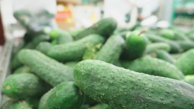 A woman in a supermarket buying vegetables