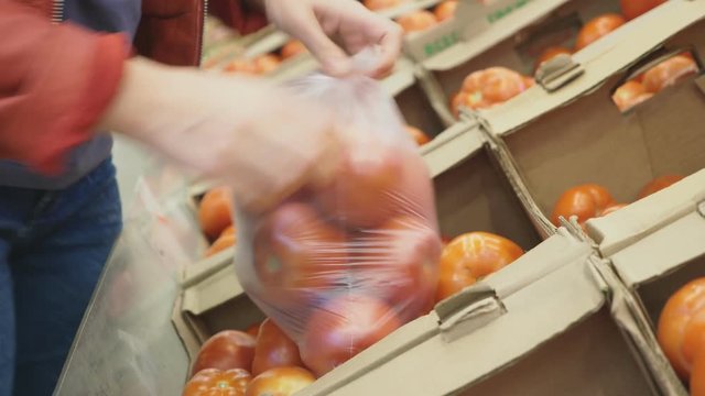 A woman in a supermarket buying vegetables