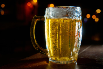 mug of beer on dark background