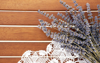 Lavender bunch and white lace on the wooden background