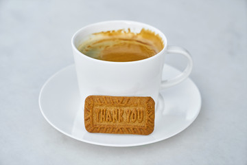 a cup of coffee with biscuit