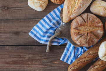 Fresh fragrant bread, rustic crusty loaves of bread and buns on the table
