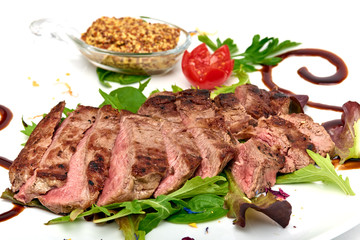 Italian food, Sirloin steak of beef with ancient mustard served on white plate, isolated on white background