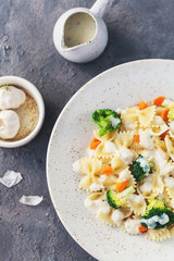 Homemade farfalle with with broccoli and carrots, bechamel