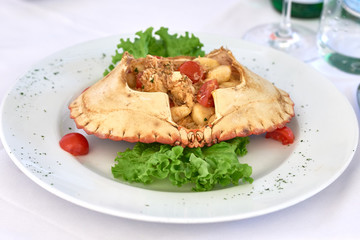Plate of homemade potato gnocchi with brown crab