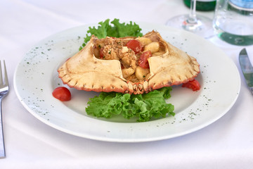 Plate of homemade potato gnocchi with brown crab
