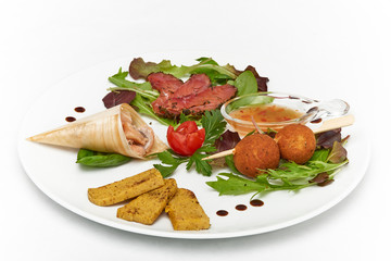 Italian food, trout tris with grilled polenta, served on white plate, isolated on white background
