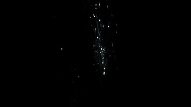 Silver glitter, falling down, on black background Fairy magic dust, or unicorn fart :-D Isolated for ease of your work process.