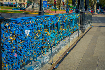 Fototapeta na wymiar Outdoor view in a row of love locks padlocks chained to footbridge over the river mapocho providencia Santiago Chile