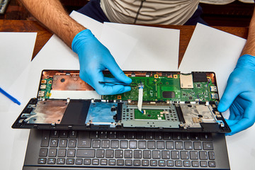 Hands of the technician repairing a computer, Professional laptop repair,Close up with selective focus