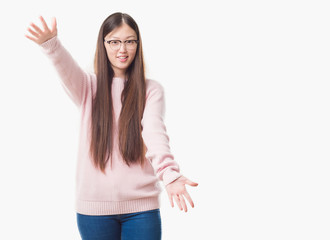 Young Chinese woman over isolated background wearing glasses looking at the camera smiling with open arms for hug. Cheerful expression embracing happiness.