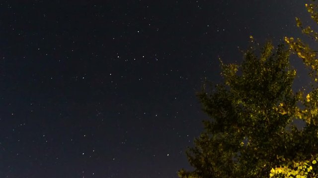 Long-exposure night time lapse shot of Milky Way's stars trails. Colorful space background: nebulas, stars, comets. Glowing galaxies and stars passing by. 4K UltraHD