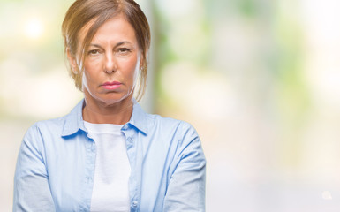 Middle age senior hispanic woman over isolated background skeptic and nervous, disapproving...