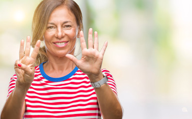 Middle age senior hispanic woman over isolated background showing and pointing up with fingers number eight while smiling confident and happy.