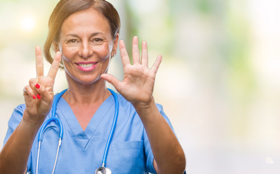 Middle age senior nurse doctor woman over isolated background showing and pointing up with fingers number seven while smiling confident and happy.