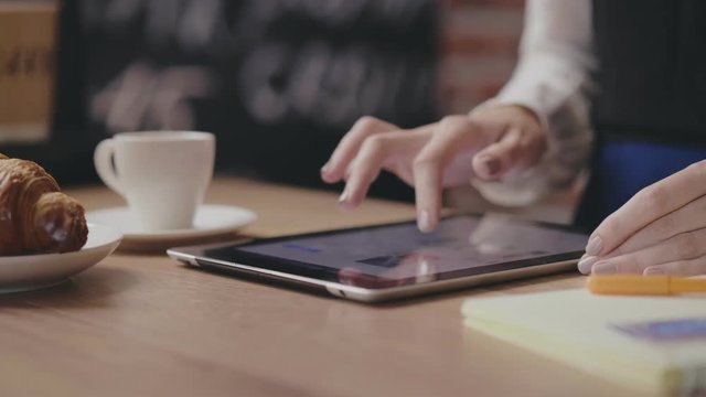 Student girl in a cafe using tablet,