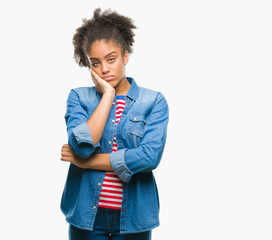 Young afro american woman over isolated background thinking looking tired and bored with depression problems with crossed arms.