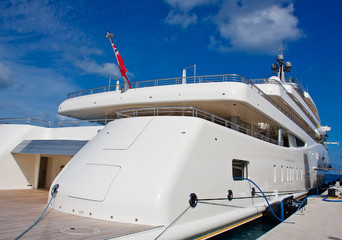 White Yacht at Dock Under Blue Skies