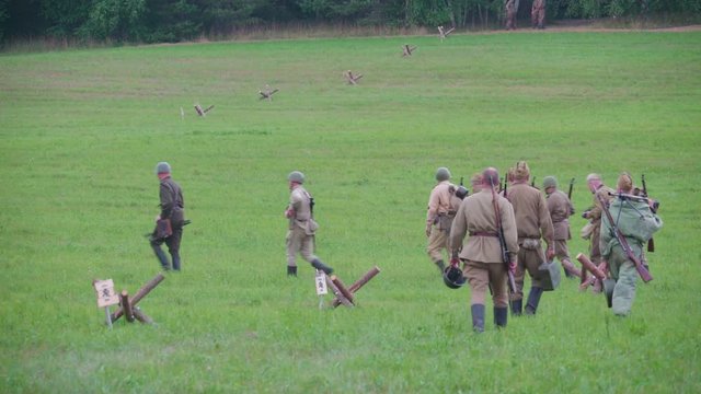 3213_Group_of_military_soldiers_walking_pass_the_grassy_lawn_in_Valga_Estonia.mov
