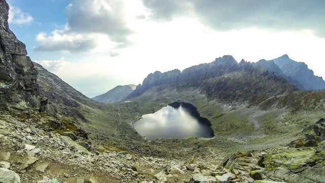 Hiking in High Tatras Mountains, Slovakia. Vysne Wahlenbergovo Pleso Lake (2154m). Mounts Ostra (2351m) on the background. Time Lapse. 4K UltraHD