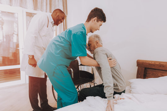 Get Out Of Bed. Nurse Helps. Elderly Man. Patient.