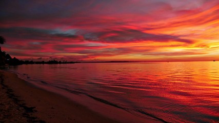 Fototapeta na wymiar Reddish skies reflected on the waters of Garapan, Saipan, Northern Mariana Islands
