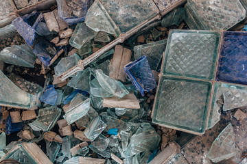 Shards of broken glass on dirty floor
