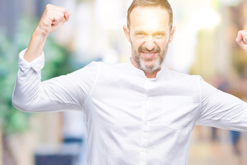 Obraz premium Middle age hoary senior man over isolated background showing arms muscles smiling proud. Fitness concept.