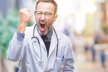 Middle age senior hoary doctor man wearing medical uniform isolated background angry and mad...