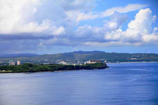 A coastal view of Guam with the business district in the distance seen from the Two Lover’s Point