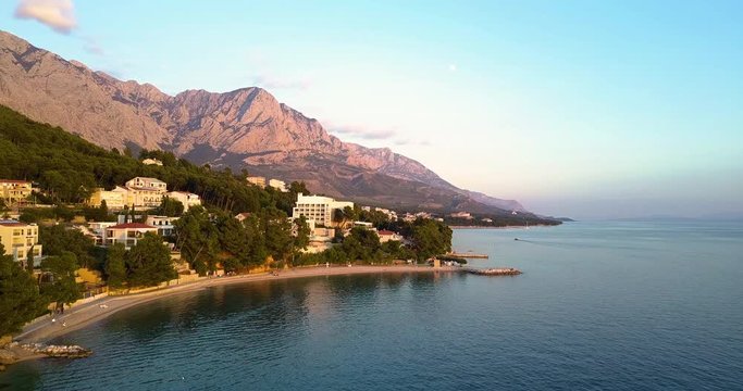 Drone shot of townscape, mountains in background, Brela, Croatia