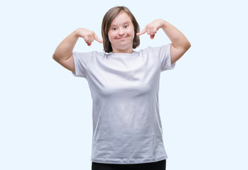Young adult woman with down syndrome over isolated background smiling confident showing and...