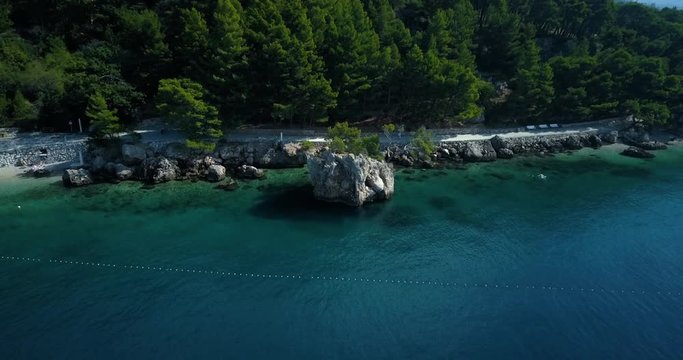 Drone shot of rocky coastline along with sea, Brela, Croatia