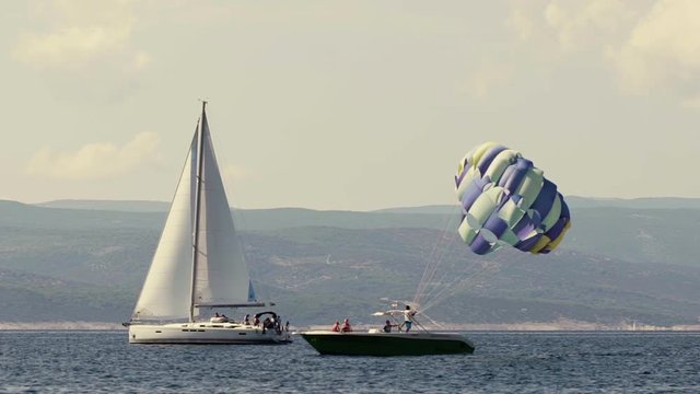 Wide shot of parasailing boat moving in sea, Brela, Croatia