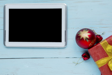 Digital tablet with Christmas ball on the table