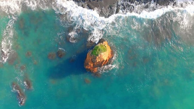 Aerial view of breaking waves at the shore reef