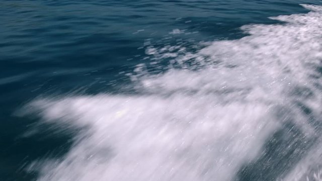 Water splashing at starboard side of the boat on blue ocean sea