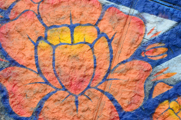 Fragment of graffiti drawings. The old wall decorated with paint stains in the style of street art...