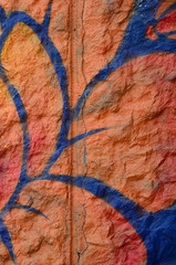 Fragment of graffiti drawings. The old wall decorated with paint stains in the style of street art...